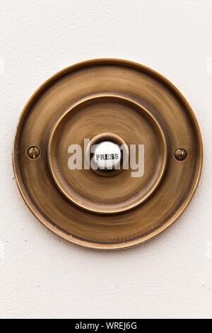 Old fashioned type brass door bell, printed with the word 'Press' Stock Photo