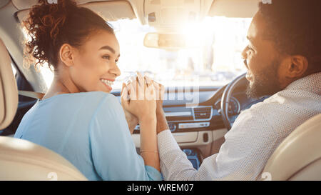 Couple looking at each other in car Stock Photo