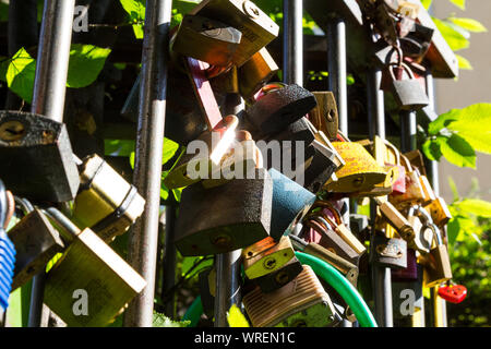 Love locks on railing shining in the sun, Sopron, Hungary Stock Photo
