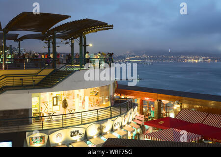 LIMA, PERU - MARCH 11, 2012: Unidentified people enjoying the view over the Pacific coast at the shopping mall Larcomar in Miraflores in the evening Stock Photo