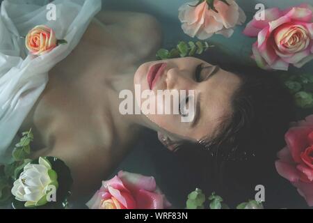 Portrait Of Young Woman In Bath With Roses
