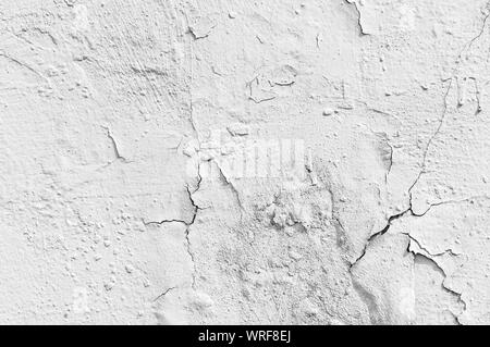 Aged white paint wall with cracks texture or background Stock Photo