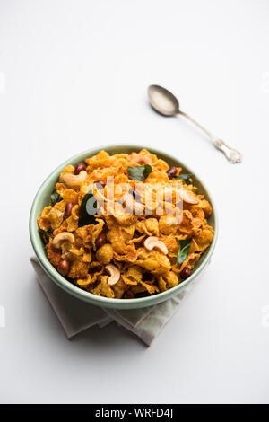 Cornflake Chivda or Corn Chiwda loaded with peanuts and Cashew. Served in a bowl. selective focus Stock Photo