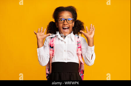 African American Elementary School Girl Shouting In Surprise, Studio Shot Stock Photo