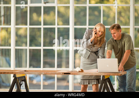 Businesswoman and contractor working together on a project. Stock Photo