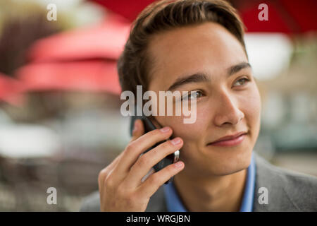 Young man talks on cell phone Stock Photo