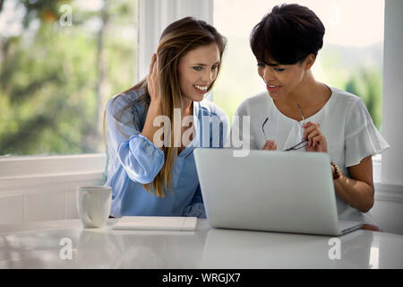 Friends working on project together from home. Stock Photo