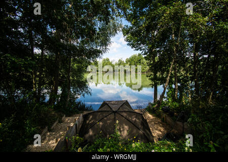 Bivvy tucked away on a french lake 2019 Stock Photo