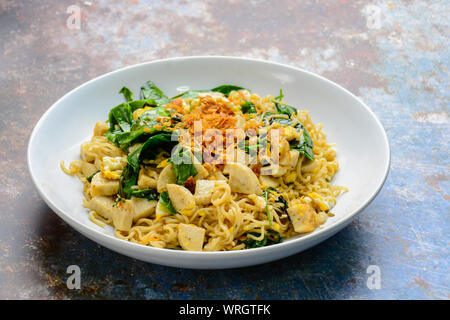 Fried noodles with Vietnamese Grilled Pork Sausage, eggs and Gnetum gnemon leaves Stock Photo