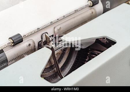 Carriage with letters in a mechanical typewriter. Letter pressed, typing. Stock Photo