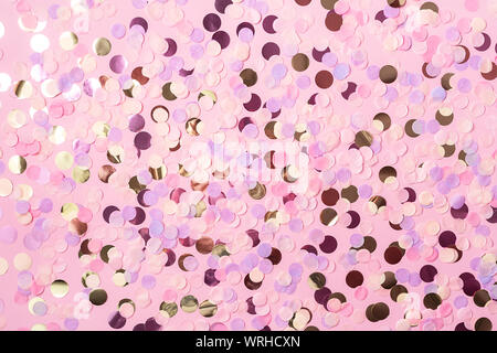 Pastel pink background with colorful round paper confetti. Holiday concept. Flat lay. Stock Photo