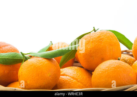 Oranges and tangerines in basket isolated on white background. Close up. Stock Photo