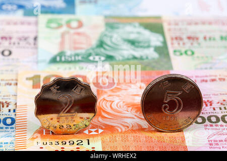 Coins from Hong Kong on a background of banknotes Stock Photo