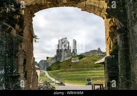 A view of Corfe Castle, looking through the gateway and entrance to the historic site in Dorset, UK, England Stock Photo