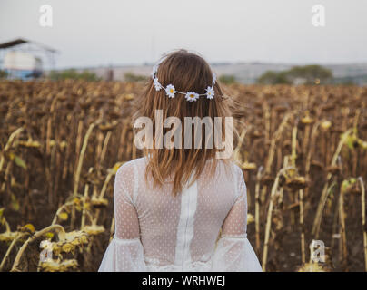 Beautiful girl with white dress in field without makeup plain and simple image Stock Photo