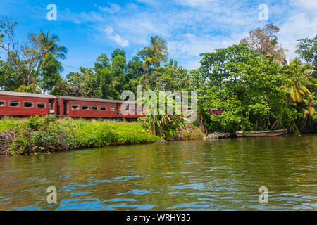 train rides along the river. Balapitiya, Sri Lanka Stock Photo