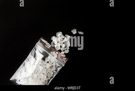 Conceptual image of 'bath salts' synthetic cathinones drugs narcotics concept. White crystal powder on black background( set up), resemble to bathroom Stock Photo