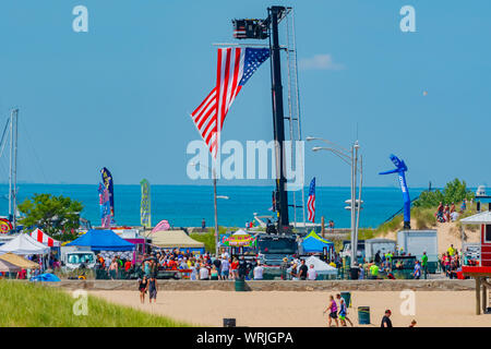 Michigan City, Indiana /  USA:  08/3/2019  Great Lakes Grand Prix Raising the Flag during the National Anthem. Stock Photo