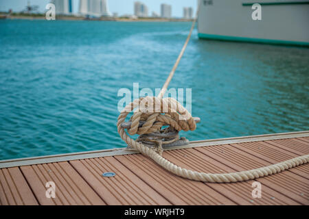 Mooring Yacht Rope With A Knotted End Tied Around A Cleat On A Wooden Pier  Stock Photo - Download Image Now - iStock