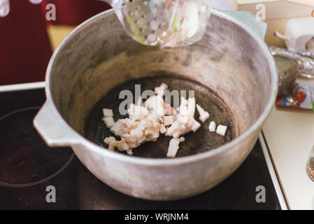 Pieces of raw lamb fat dumba are fried in a black cauldron, cooking food  Stock Photo - Alamy