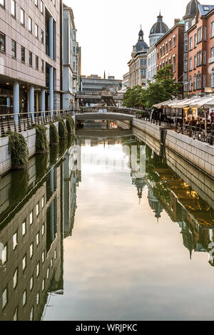 Downtown Aarhus with the canal and restaurants in the evening, reflecting in the water, Denmark, July 15, 2019 Downtown Aarhus with the canal and restaurants in the evening, reflecting in the water, Denmark, July 15, 2019