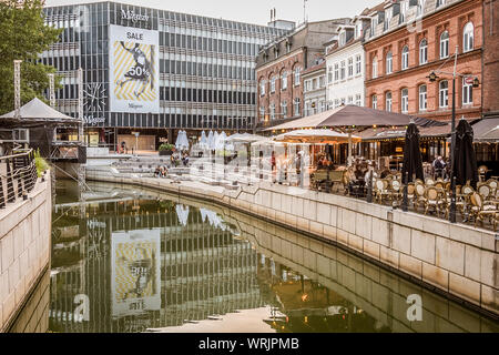Aarhus city with a variety of restaurants and buildings reflecting in the canal, Denmark, July 15, 2019