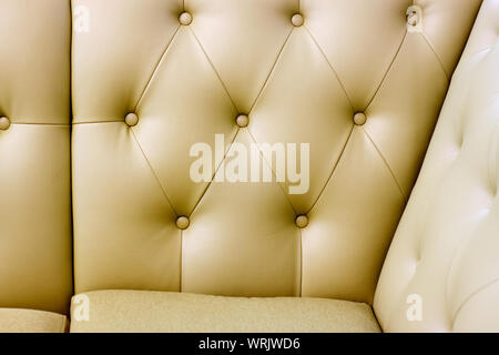 Close up of a carriage tie on a leather sofa, background or concept, selective focus Stock Photo