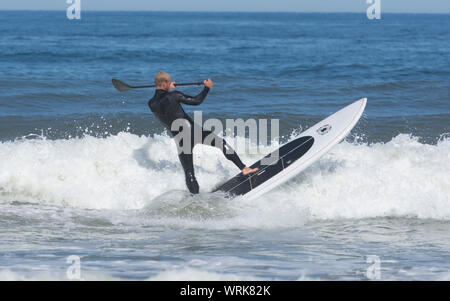 Surfing/paddleboarding on Newcomb Hollow Beach, Wellfleet, Massachusetts on Cape Cod, USA Stock Photo