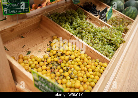 Mirabelle plums and grapes for sale at the covered market near Little Venice in Colmar, France. Stock Photo