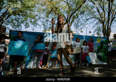 Children in front of a banner with a indigenous protester in a pro environment walk, protest during the brazilian independence day Stock Photo