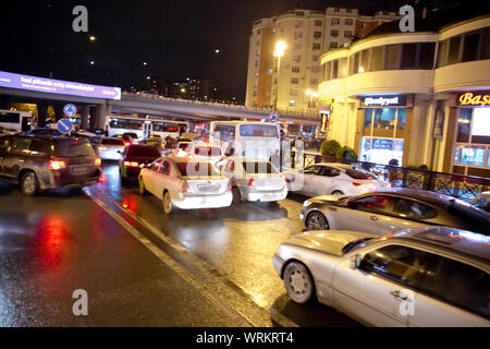 Evening traffic jam in Baku on one of streets in the downtown . Queue of cars on the street during the rush hour . Traffic jam in the rush hour . Stock Photo