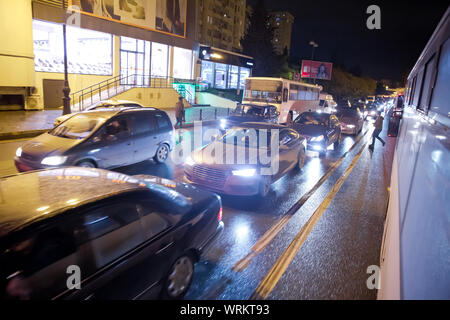 Evening traffic jam in Baku on one of streets in the downtown . Queue of cars on the street during the rush hour . Traffic jam in the rush hour . Stock Photo