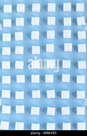 Repeating pattern with sugar cubes, blue background, wallpaper. selective focus Stock Photo