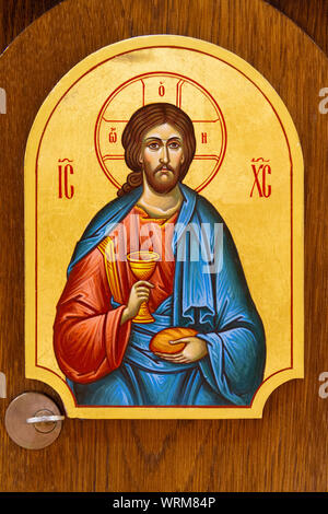 The icon of Jesus Christ with bread and wine in His hands. The icon is on the Eucharistic tabernacle. The Greek Catholic Church of Saint Elijah. Stock Photo