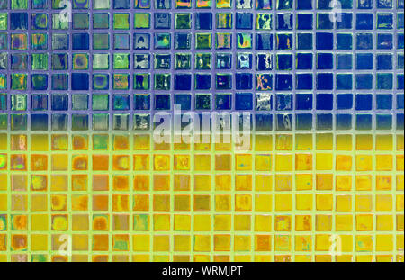 Tiled wall made by translucent tiles where colors form the flag of Ukraine Stock Photo