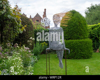 Chenies Manor from the topiary garden. Sculptures by Jenny Pickford, Dandelion, and Rachel Ducker's wirework..marhueri Stock Photo