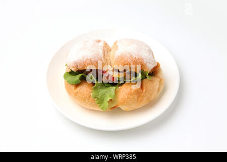 fried chicken hamburger lettuce on plate closeup isolated on white background Stock Photo