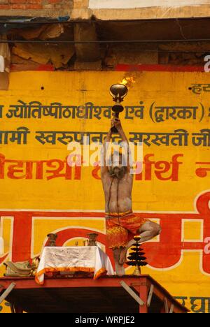 Hindu ritual of a holy man in Ganges river (Varanasi). Stock Photo