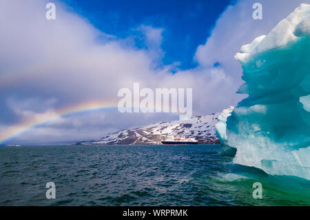 HORNSUND, SVALBARD, NORWAY – JULY 26, 2010:  National Geographic Explorer cruise ship in front of a glacier in the Arctic Ocean. Stock Photo