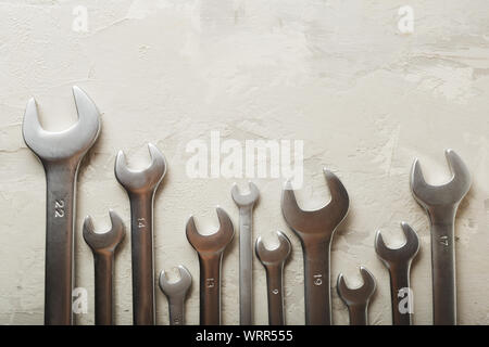 Spanners. Many wrenches. Industrial background. Set of wrench tool equipment. Set of wrenches in different sizes on grey background. Top view with Stock Photo