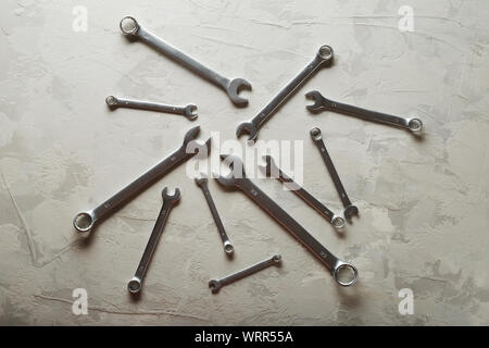 Spanners. Many wrenches. Industrial background. Set of wrench tool equipment. Set of wrenches in different sizes on grey background. Top view with Stock Photo
