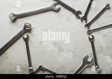 Spanners. Many wrenches. Industrial background. Set of wrench tool equipment. Set of wrenches in different sizes on grey background. Top view with Stock Photo