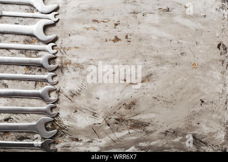 Spanners. Many wrenches. Industrial background. Set of wrench tool equipment. Set of wrenches in different sizes on grey background. Top view with Stock Photo