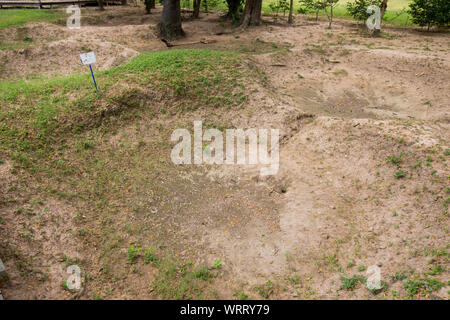 The location of one of the many killing fields mass grave pits at the Choeung Ek Genocidal Center, outiside Phnom Penh, Cambodia. Stock Photo