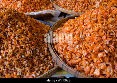 Piles of orange dried shrimp, sorted into neat cone piles by size, are for sale at the main Central Market in Phnom Penh, Cambodia. Stock Photo
