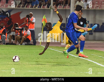 Kuwait City, Kuwait. 10th Sep, 2019. Awer Mabil (Back) of Australia vies with Sultan Alenezi of Kuwait during the FIFA World Cup Qatar 2022 and AFC Asian Cup 2023 Preliminary Joint Qualification Second round group B football match between Kuwait and Australia in Kuwait City, Kuwait, on Sept. 10, 2019. Credit: Asad/Xinhua Stock Photo