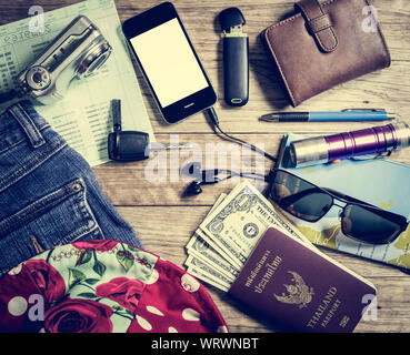Set of travel accessory with budget on vintage wooden table background Stock Photo