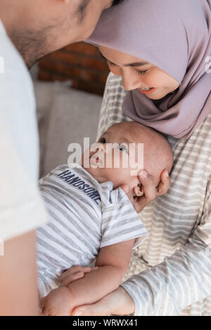 asian family with infant son together smiling Stock Photo
