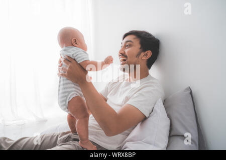 father carry his baby son playing together Stock Photo