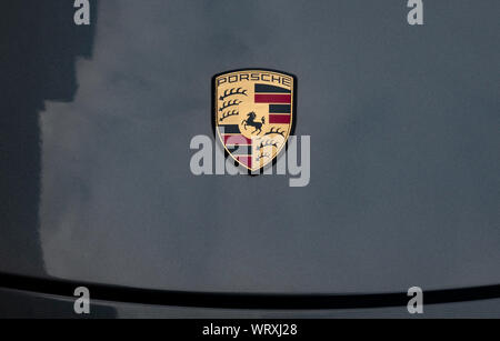 Porsche badge on car hood Stock Photo